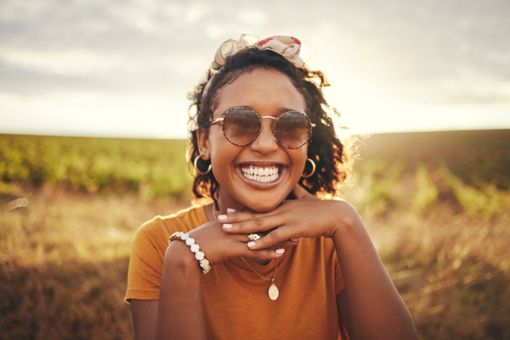 Face smile, black woman and countryside sunglasses, summer vacation or holiday. Portrait, travel an