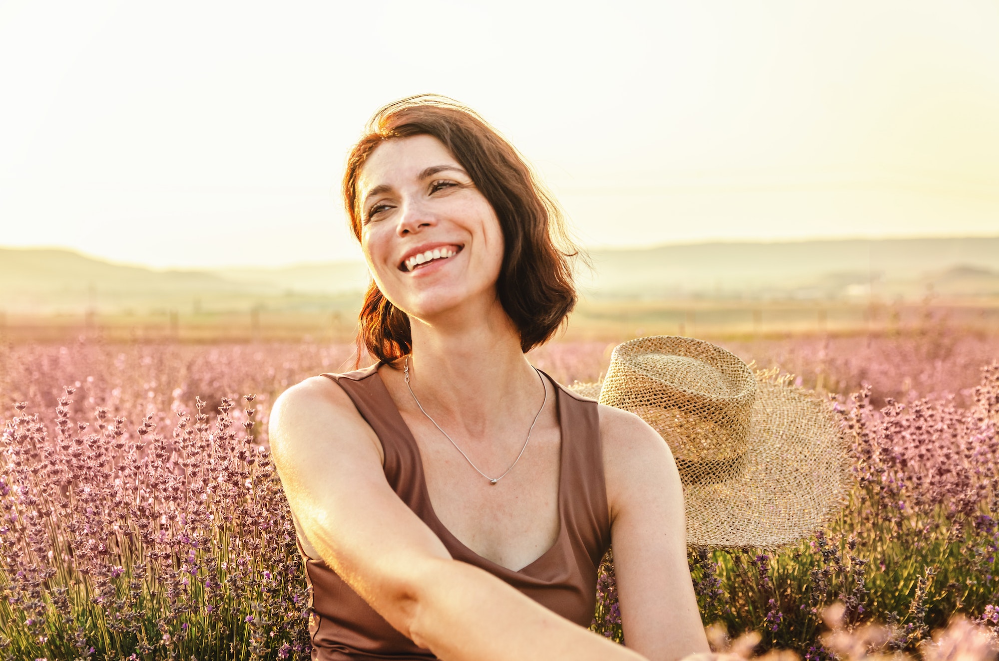 laughing girl on a lavender field at sunset